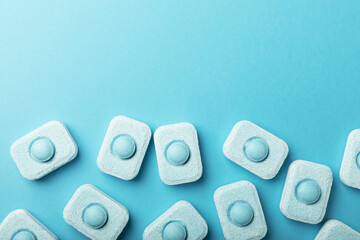 Water softener tablets on a blue background
.FLAT LAY. Place for text.Space for copy.Top view....