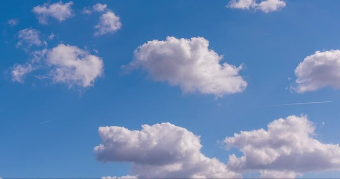 blue sky with clouds and airplane condensation trail timelapse