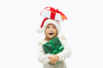 Christmas child. Cute toddler girl  in santa claus caps holding colorful gift boxes on white. Wow fanny face. Preparing for New Year's holidays in Italy