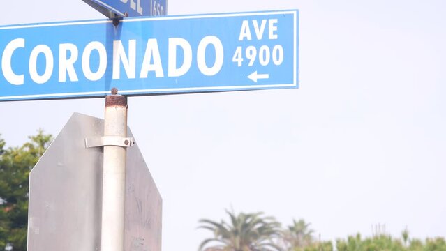 Coronado road sign on crossroad, California city street, USA. Waterfront tourist resort near Los Angeles, beachfront travel destination for waterside summer coastal vacations.