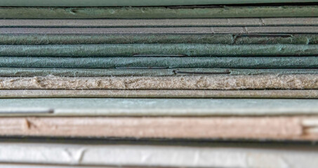 Close up of a the stapled spines of paper bound 19th century note books