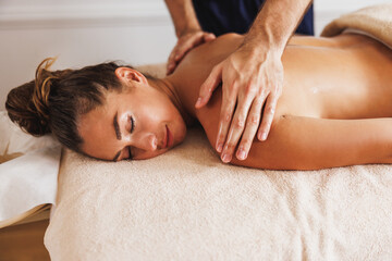 Obraz na płótnie Canvas Woman Enjoying Massage In Spa Centre