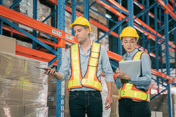 Caucasian man, woman warehouse supervisor wear safety discuss,talk and use clipboard check box package on shelf, product distribution inventory management,Logistics shipping business planning industry