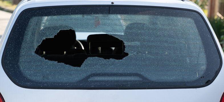 closeup of broken rear windshield glass on the back of a car