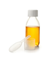 Bottle of cough syrup, spoon and cup on white background