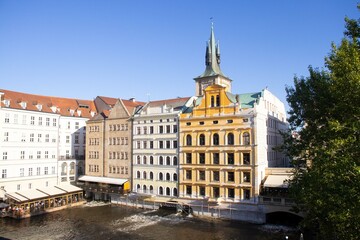 Fototapeta premium Prague, Czech Republic - The view on the water of buildings from the Charles Bridge