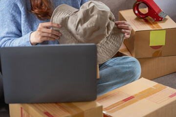 Young Asian SME businessman starting a small and boxed SME business as an online business. Online SME business concept.