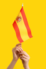 Woman with flag of Spain on yellow background