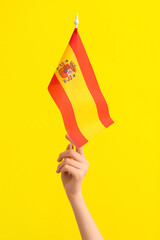 Woman with flag of Spain on yellow background