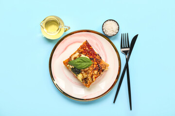 Plate with piece of tasty Italian pie, salt and oil on color background