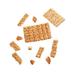 Whole and crushed sesame kozinaki bars isolated on white background