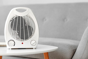 Electric fan heater on table in living room