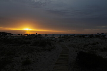 Summer sunrise over Golden Beach (Skala Potamias) in Greece with an overcast sky.