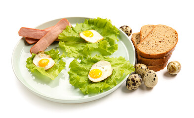 Plate with tasty fried quail eggs and sausages on white background