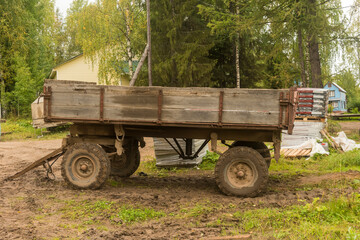 Fototapeta na wymiar a large trailer with a wooden body for agricultural work on the farm.