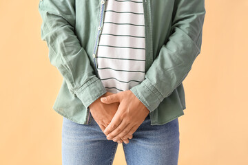 Man with prostate problem on beige background, closeup