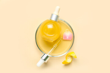 Bowl with bottle of citrus serum on color background