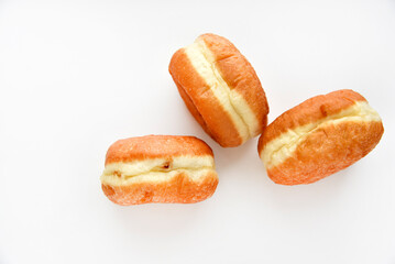 Delicious buns with jam on a white background. Sweet doughnuts with stuffing close-up.