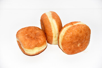 Delicious buns with jam on a white background. Sweet doughnuts with stuffing close-up.