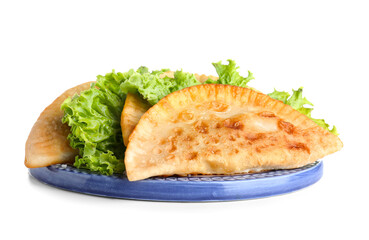 Plate with tasty chebureks and lettuce on white background