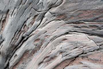 Full-frame close-up of a grey volcanic rock face, probably basalt, in Dritvík Bay, Iceland, suitable as a lava background texture.