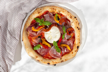 Close up view on Appetizing with burrata cheese, tomatoes and basil. Pizza in composition. Italian cuisine. Food flat lay