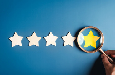 Customer use magnifier glass focus to five stars icon rating service for satisfaction evaluation...