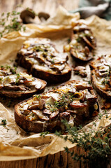 Fototapeta na wymiar Grilled mushroom sandwich with addition cheese and aromatic thyme, close up view