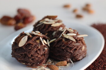 Ragi dates Sheera. Indian pudding made of finger millet flour ghee, milk, dates and dry fruits. Traditionally known as ragi halwa.