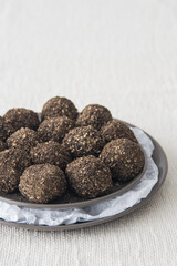 Small Swiss hard cheese balls Belper Knolle made from cow's milk in black pepper on a plate, selective focus