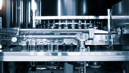 pharmaceutical industry, medicine pills are filling in the  bottle on production line machine...