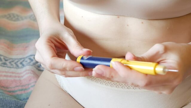 Female makes injection in stomach, belly or abdomen. IVF in vitro fertilisation, reproductive infertility, sterility treatment. Hormonal drugs, ovulation stimulation. Woman injecting insulin, diabetes