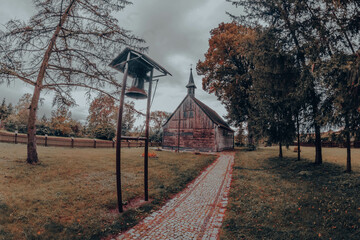 old wooden church in autumnal park 