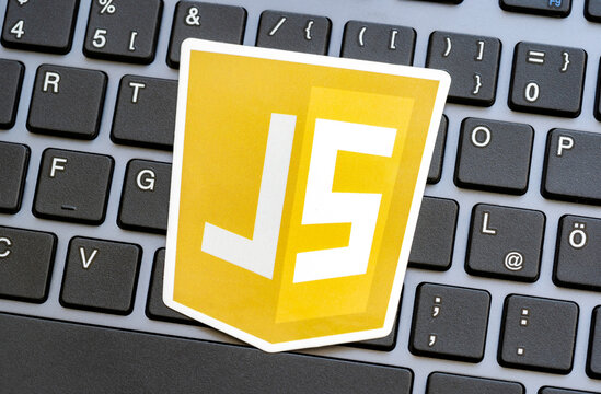 JS, JavaScript programming language logo laying on a modern computer keyboard, nobody. Web development, browser scripts, web page scripting security concept, technology