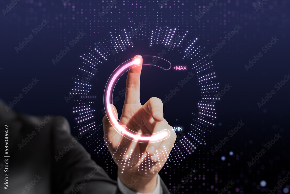 Poster Close up of businessman hand pointing at abstract glowing max and min scale hologram on dark background. Volume control and future concept.