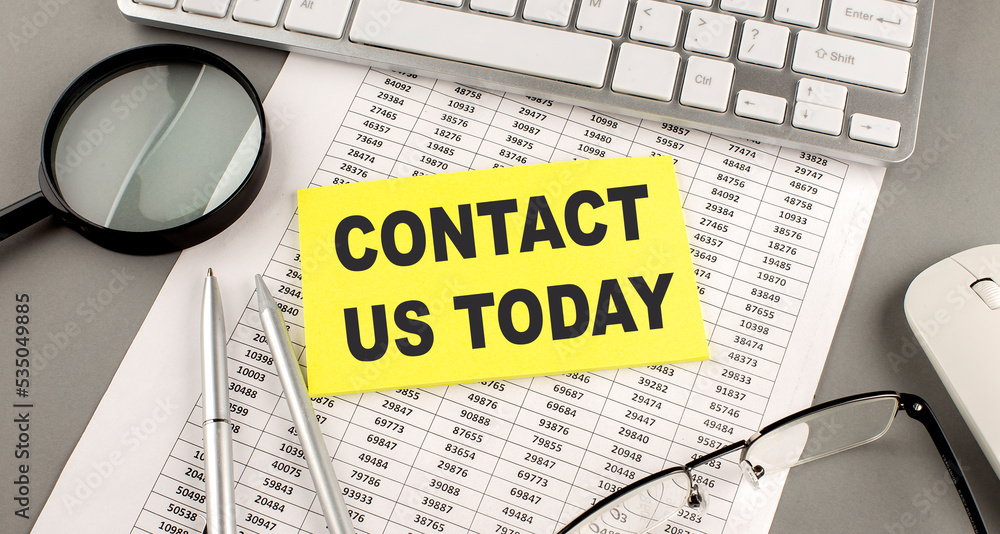 Aufkleber contact us today text written on a sticky on chart with keyboard and magnifier