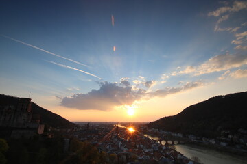 View over Heidelberg in the evening. Sunset on the horizon, view over the old town, the castle and the river Neckar on a warm summer day
