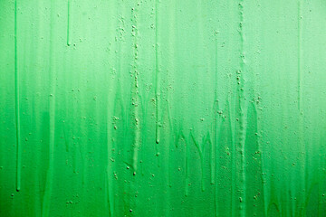 green background - the surface painted with green paint - the surface is not even, covered with paint, a lot of dried dripping drops, part of the surface is faded
