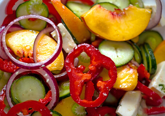 Salad of bell peppers, cucumbers, peaches, celery, red onions and sesame seeds. Vegan food and...
