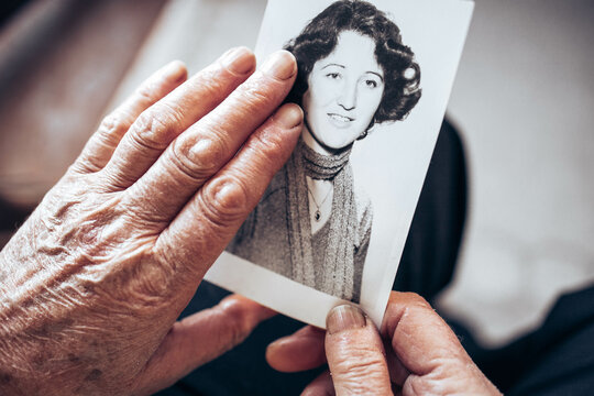 CIRCA 1970: Elderly woman hands holding vintage, black and white photo