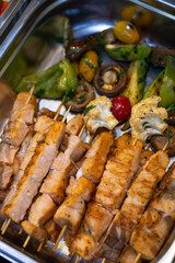 chicken kebab on a wooden stick in marmite top view