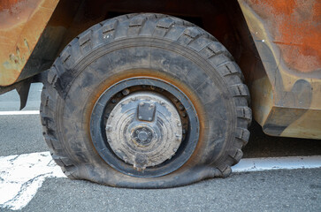 Close-up of vehicle with flat rear tire or puncture wheel on road