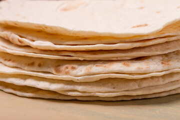 A stack of Mexican tortillas, on a gray table, top view, close-up, no people,