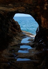 Picturesque sea view through the rock hole near Megalo Livadi on Serifos island in Greece