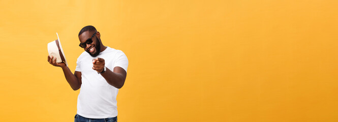 Fototapeta na wymiar Young black man top dancing isolated on a yellow background.