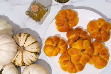 pumpkin buns on white table