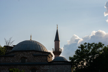 Minaret of a mosque in view. Silhouettes of Mosque