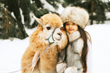 cute beautiful asian girl in fashion stylish winter clothes fur coat and fur hat walking and...