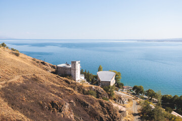 Fototapeta na wymiar Sevan Lake, Armenia, beautiful aerial panoramic view of Sevan Lake, Gegharkunik Province, with Sevanavank monastery chapel in a summer sunny day