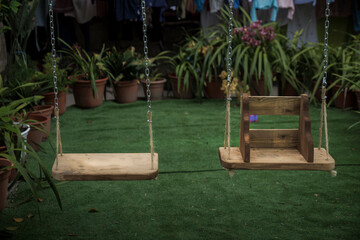 Detail of wooden swings for children to have fun remembering old times.